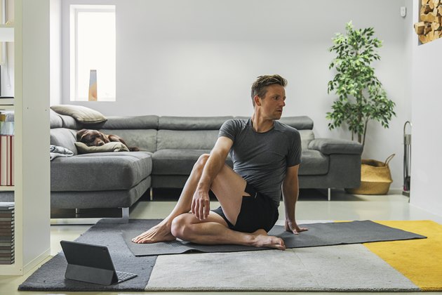 Man practising yoga at home