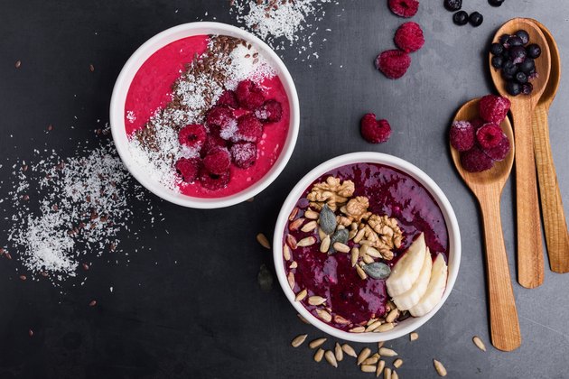 Breakfast smoothie bowls with frozen blueberries and raspberries