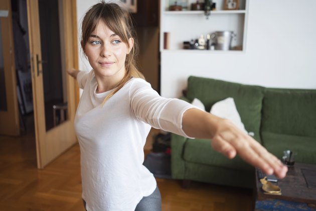 Young woman practicing yoga at home