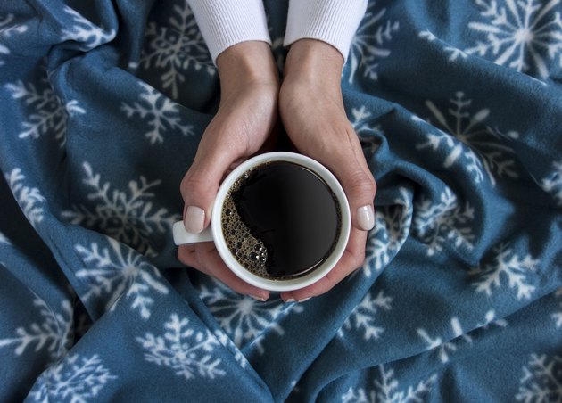 holding a cup of coffee
