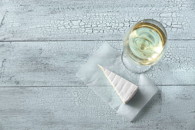 Glass of white wine with Brie
