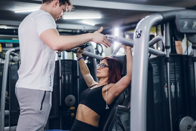 Working out with shoulder press machine