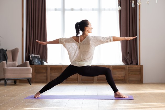 Woman in war pose doing yoga