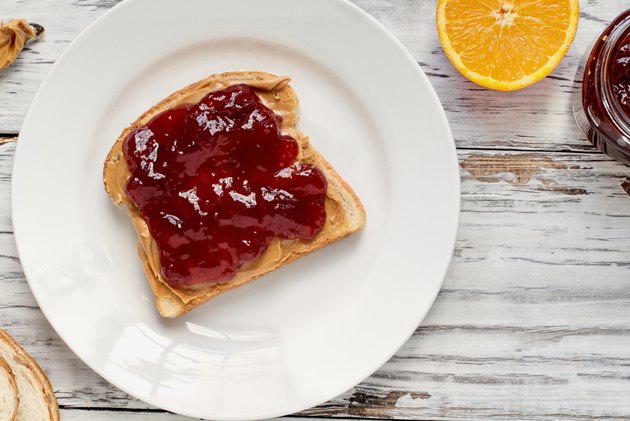 Open face homemade peanut butter and strawberry Jelly sandwich