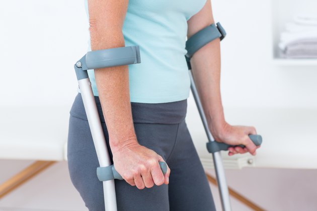 Woman standing with crutch