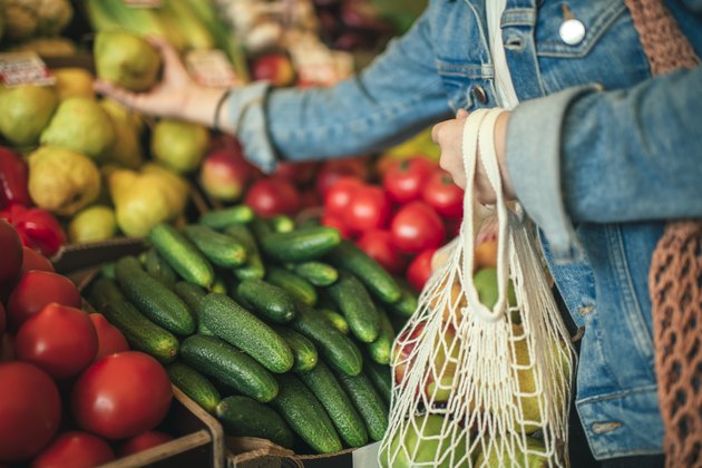 Vegetables and fruit in reusable bag on a farmers market, zero waste concept