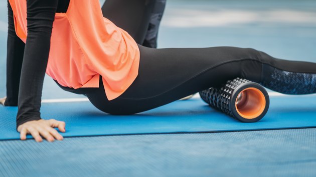 Midsection Of Woman Exercising On Mat