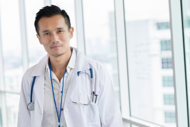 Medical doctor in lab coat looking serious