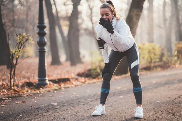 sleep-deprived woman yawning during a workout
