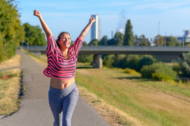 Happy fit woman cheering and celebrating after losing 100 pounds