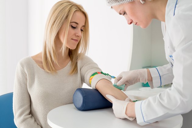 Woman and doctor preparing for blood test