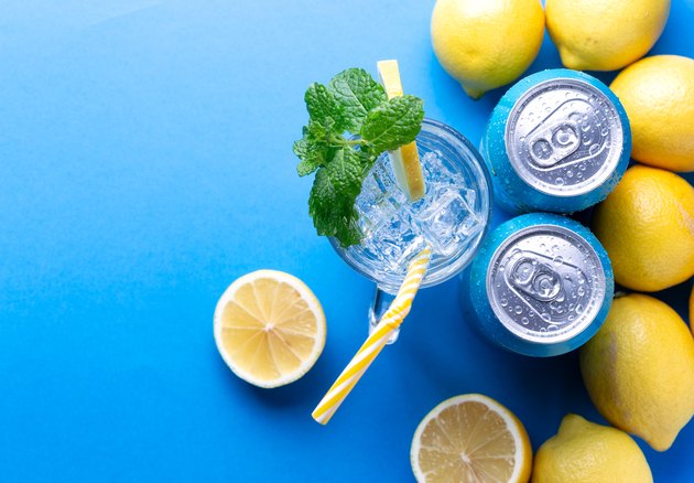 Soda drink with lemon and aluminium cans
