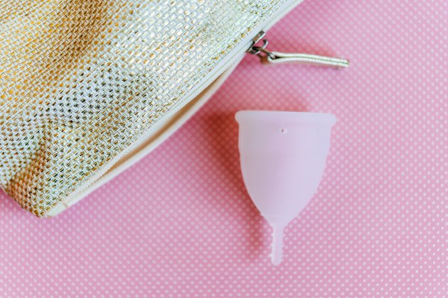 Menstrual cup on pink background