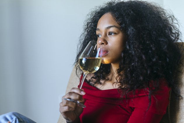 woman drinking glass of white wine