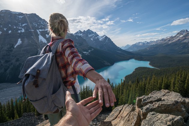 Follow me to, young woman leading man to mountain top