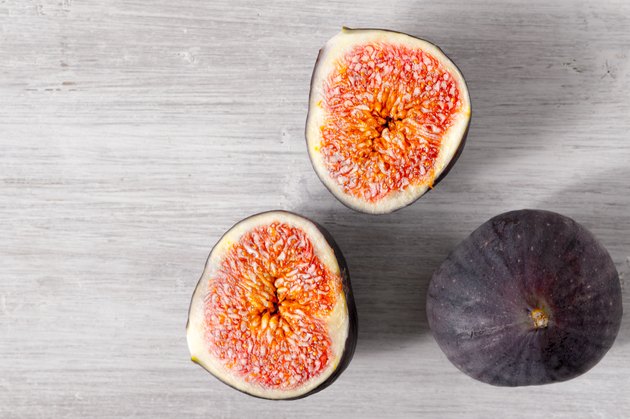 Figs on the white wooden table top view