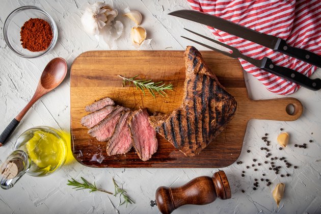 sliced tri tip seak marinated with santa maria sauce on wooden cutting board