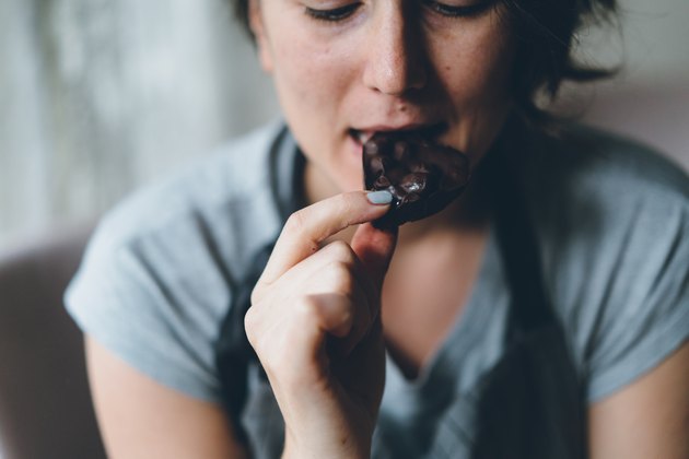 Woman eating chocolate and sweating while eating