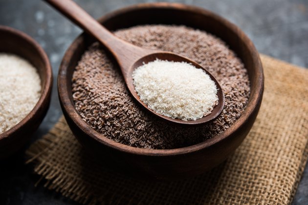 Psyllium husk or isabgol which is fiber derived from the seeds of Plantago ovata, mainly found in India. Served in a bowl over moody background. selective focus