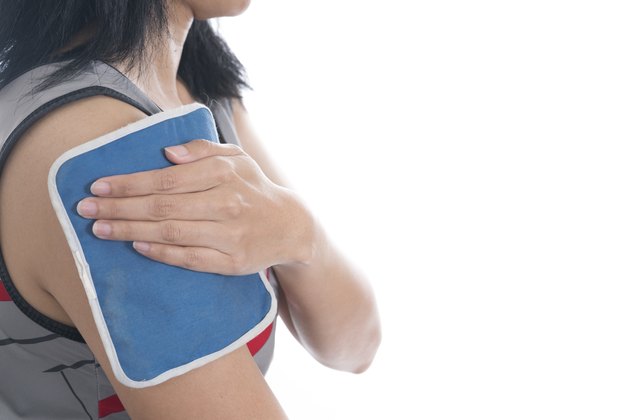 woman putting an ice pack on her shoulder pain