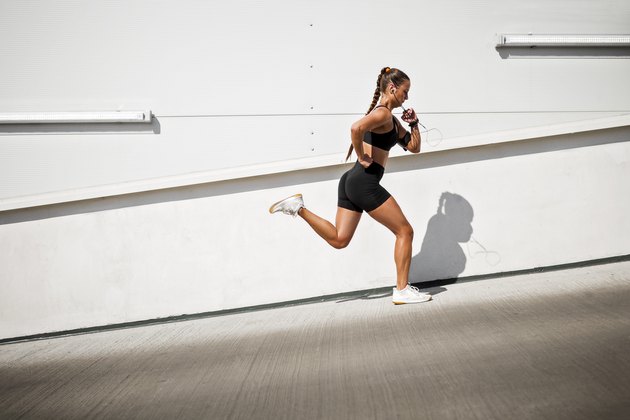 Young sportswoman running outdoors on a sunny day