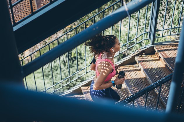 Sports Woman running up a staircase