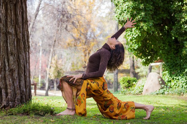 Woman practices yoga in the park