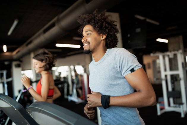 Group of young people running on treadmills as part of their 5-day cardio workout plan