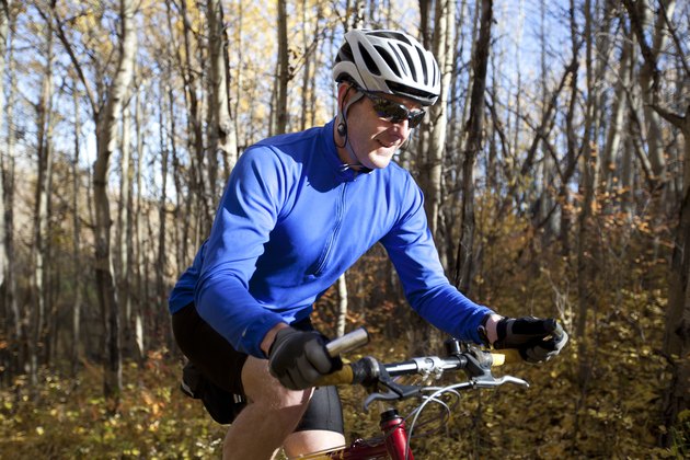 Man mountain biking for low-impact cardio with knee pain