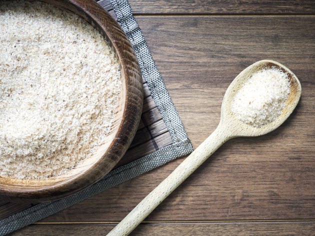 Psyllium husk (ispaghula) on dark wooden background