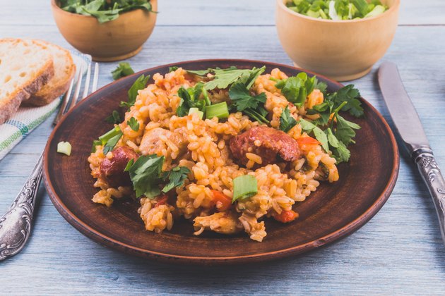 Jambalaya rice chicken and smoked sausage on rustic wooden background