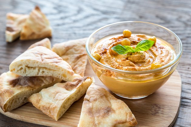 Bowl of hummus with pita slices