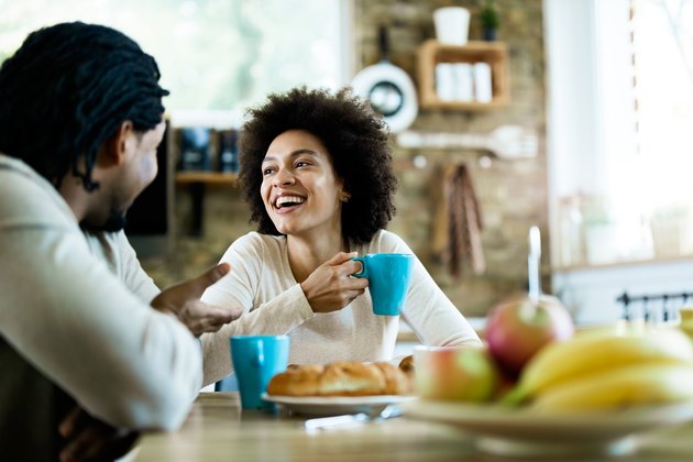 happy couple eating a healthy filling breakfast to avoid overeating later