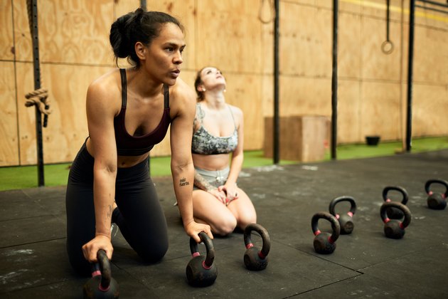 Two hispanic women tired and resting after doing a long series of push-ups.