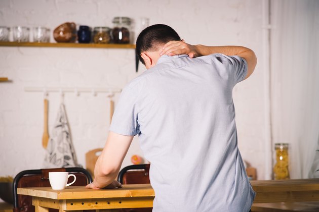Neck pain, man suffering from upper back pain