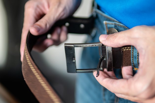 A man wearing leather belt with jeans