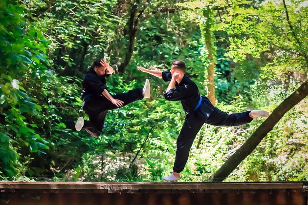 Two boys practicing martial arts. Kick and punch fighting