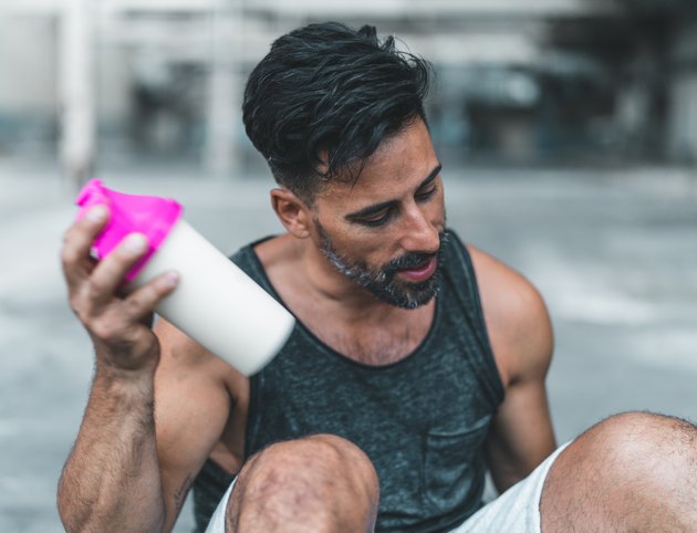 what to eat to gain muscle man mixing a Protein Shake after Exercising