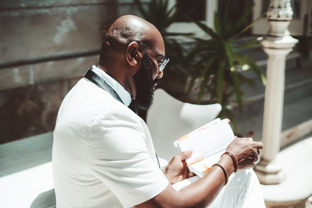 Black man with a book outside
