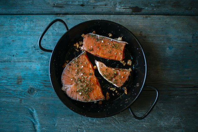 Salmon fillets in pan with parsley and garlic