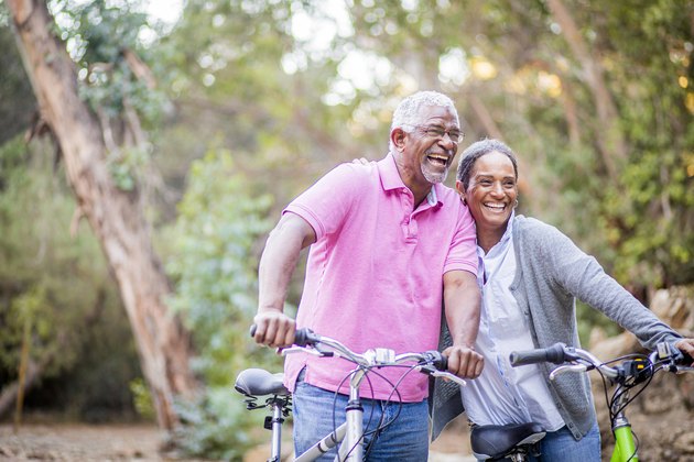 Senior African-American couple riding bikes together to help prevent type 2 diabetes