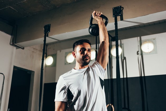 Man working out with a kettlebell in a gym