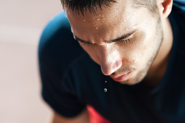 A male runner sweating profusely after a workout
