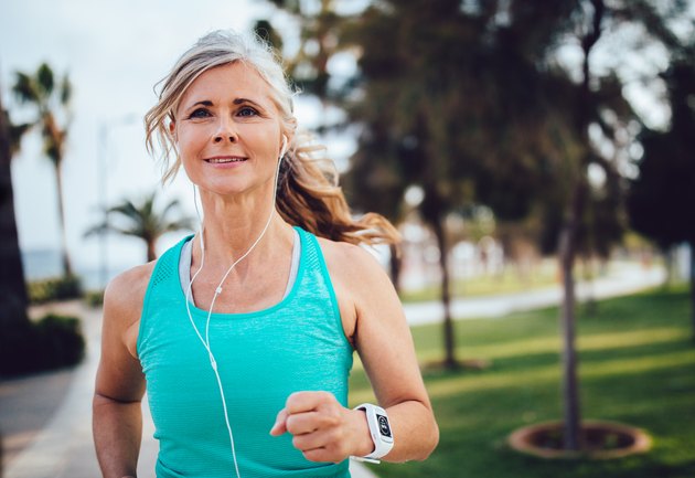 An active mature woman running in the park