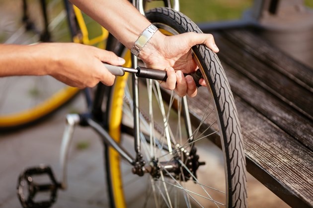 Man Inflating a Bike Tire