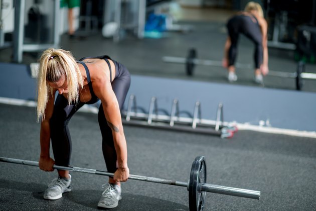 Woman doing barbell deadlift