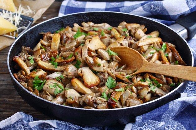 fried porcini mushrooms with parsley in skillet