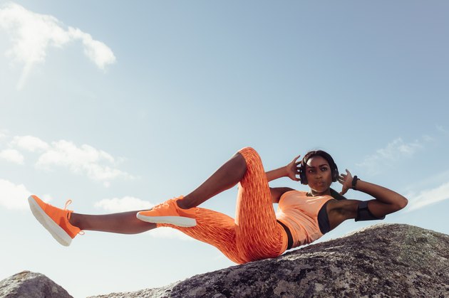Fit woman stretching at the beach