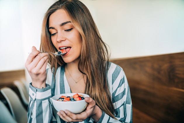 woman close up eating oatmeal for breakfast