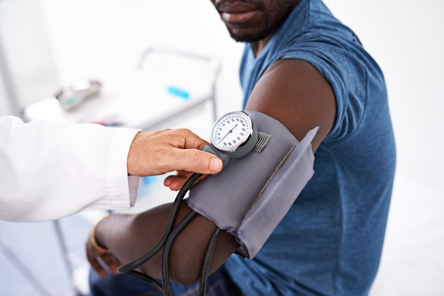 Close view of a doctor taking a man's blood pressure